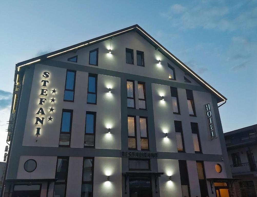 a building with a sign on the side of it at Hotel Stefani in Sibiu