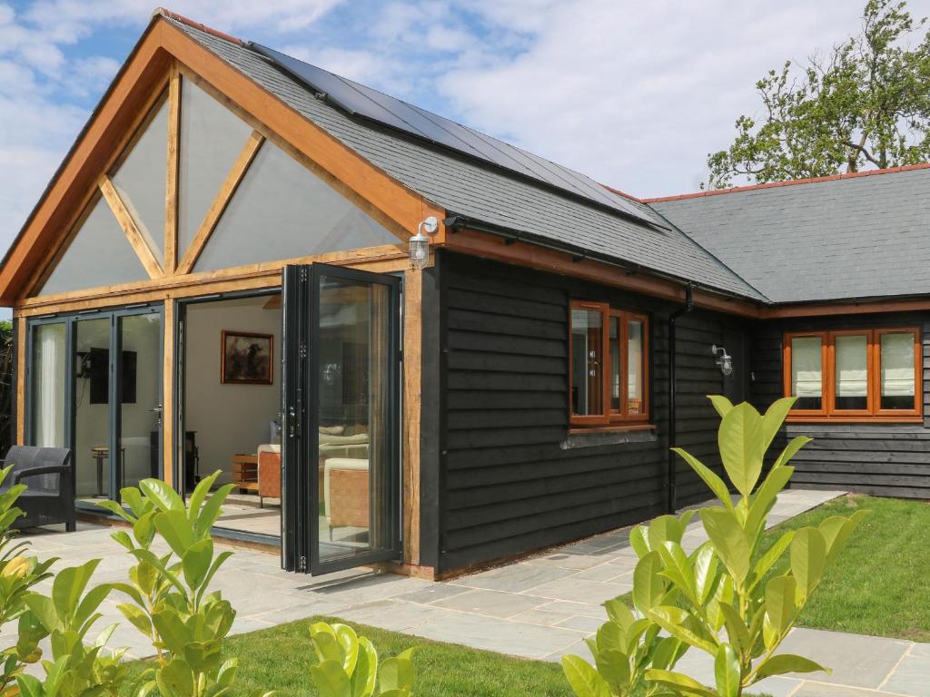 a house with black siding and glass doors at Lapwings in Fareham
