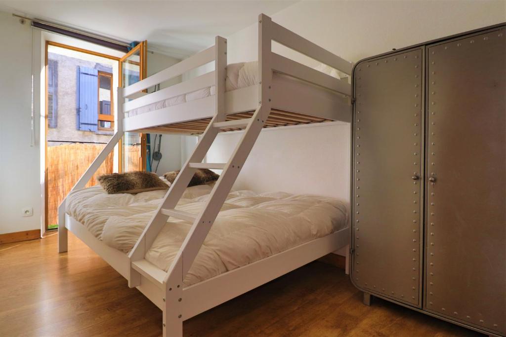 a bunk bed with two cats sleeping on it at Superbe appartement esprit chalet in Barcelonnette