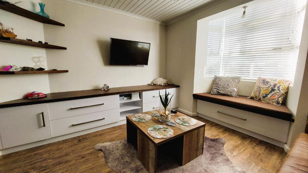 a living room with a couch and a table at Nautilus 2 bedroom self-catering apartment in Swakopmund