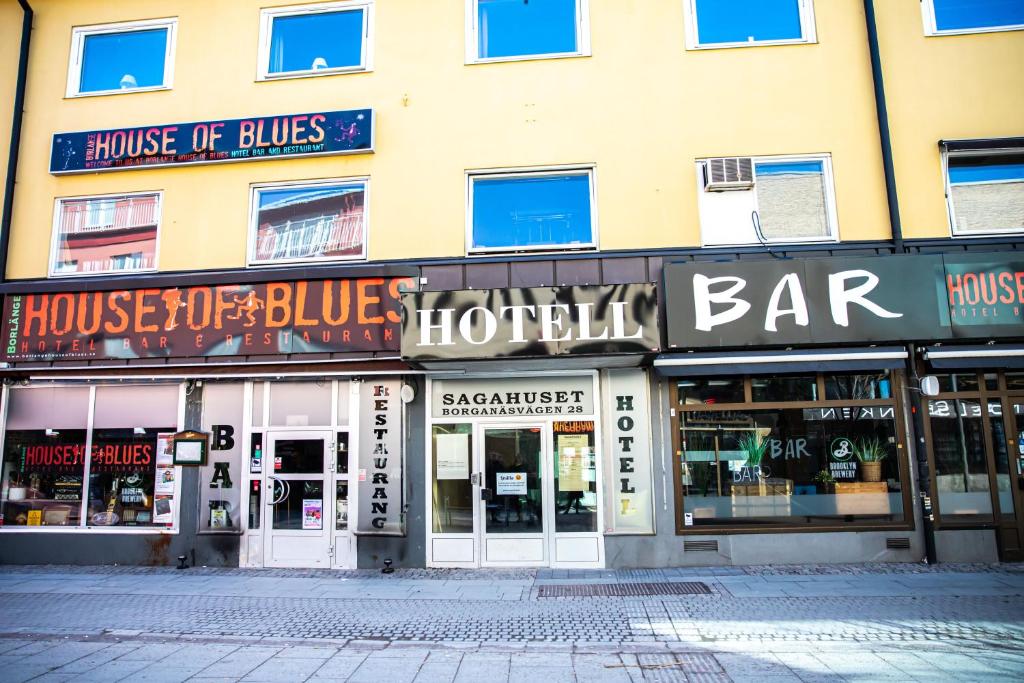 a large building with shops on a street at Saga Hotell in Borlänge