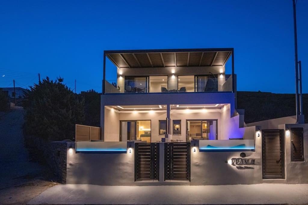 a large house at night with the lights on at Pearl Suites and Villa Tinos in Tinos Town