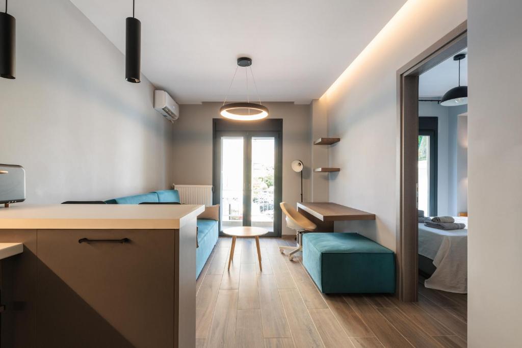 a kitchen and living room with a desk and a table at Hippocrates bound by BiNoBi! in Thessaloniki