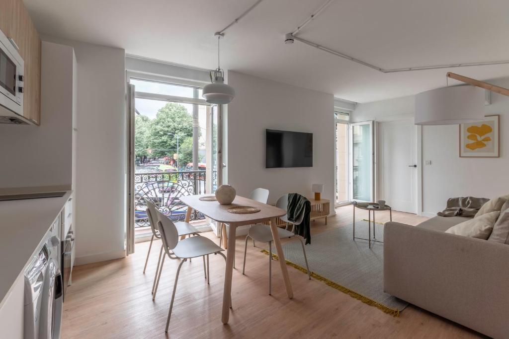 a kitchen and living room with a table and chairs at B48 Abando in Bilbao