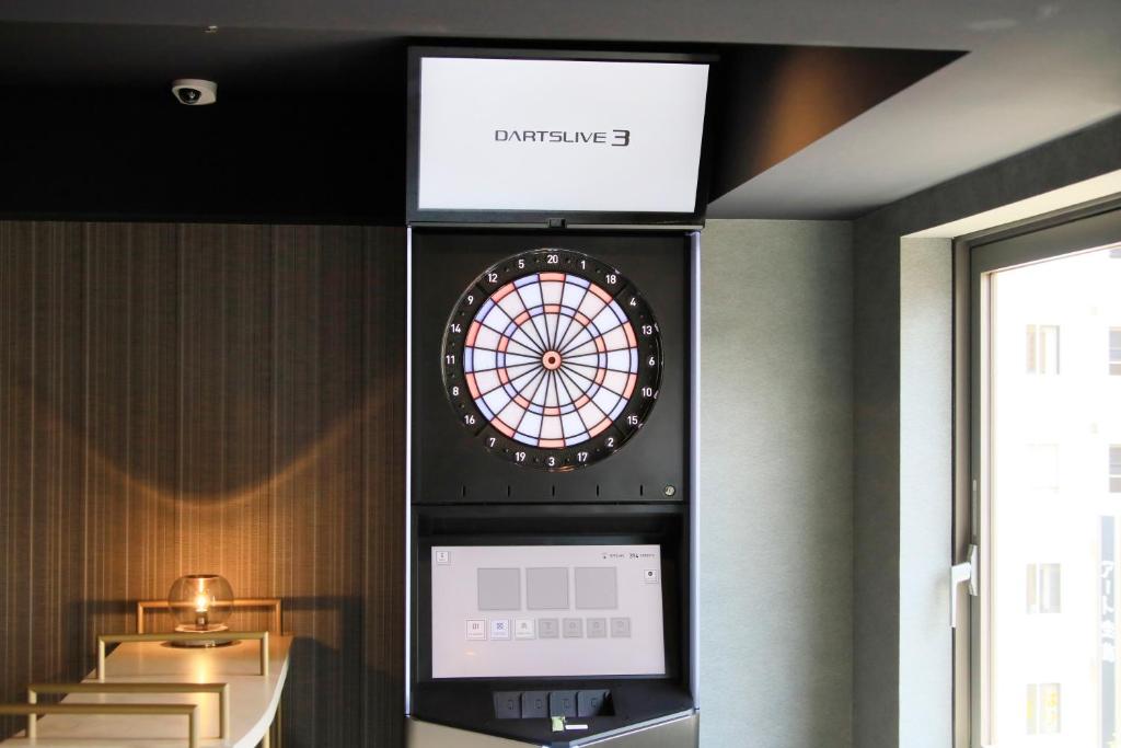 a dart board on a wall in a room at Richmond Hotel Yokohama-Bashamichi in Yokohama