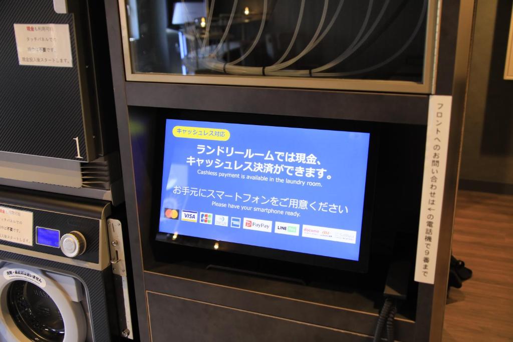 a microwave oven with a sign on top of it at Richmond Hotel Yokohama-Bashamichi in Yokohama