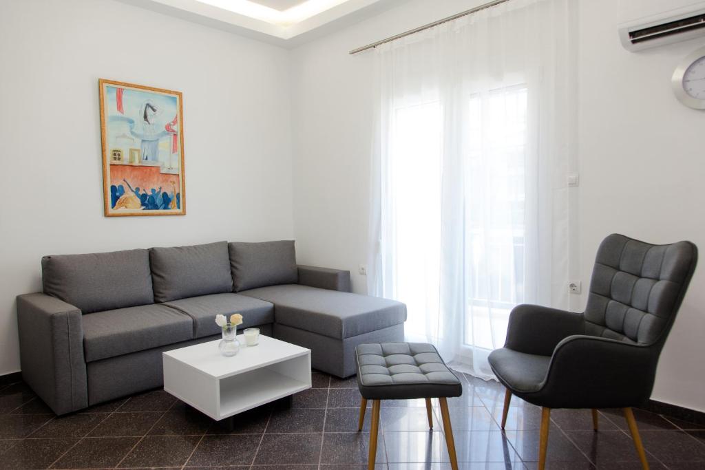 a living room with a couch and two chairs at Downtown supreme apartment kavala in Kavála