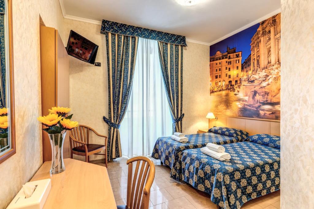 a hotel room with a bed and a table at Hotel Orlanda in Rome