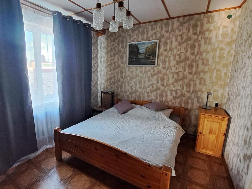 a bedroom with a bed in a room with a window at Liepājas brīvdienu māja ar dārzu in Liepāja