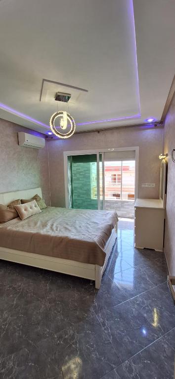 a bedroom with a large bed in a room at Appartement moderne haut standing avec balcon et clim à 2 min de la plage in Saïdia