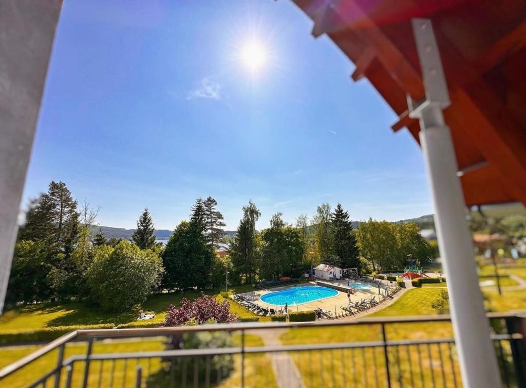a view of a swimming pool from a balcony at Lipno Holiday Penthouse in Lipno nad Vltavou