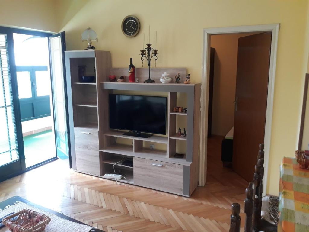 a entertainment center with a television in a living room at Bulevar apartment Budva in Budva