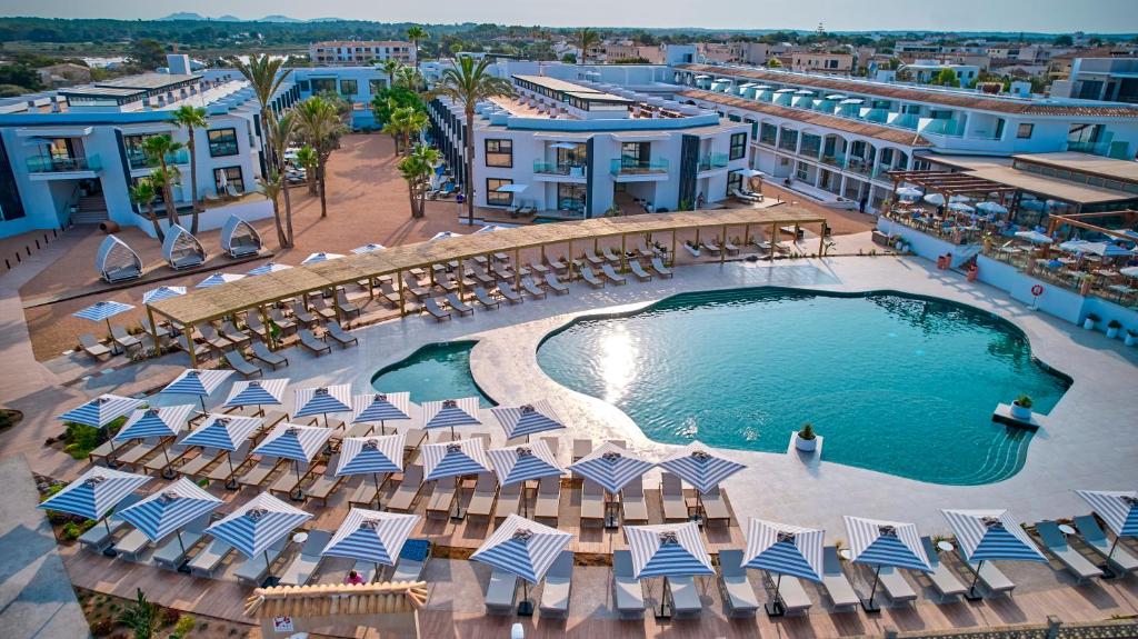 einen Luftblick auf ein Resort mit einem Pool und Liegestühlen in der Unterkunft Universal Grand León & Spa in Colonia Sant Jordi