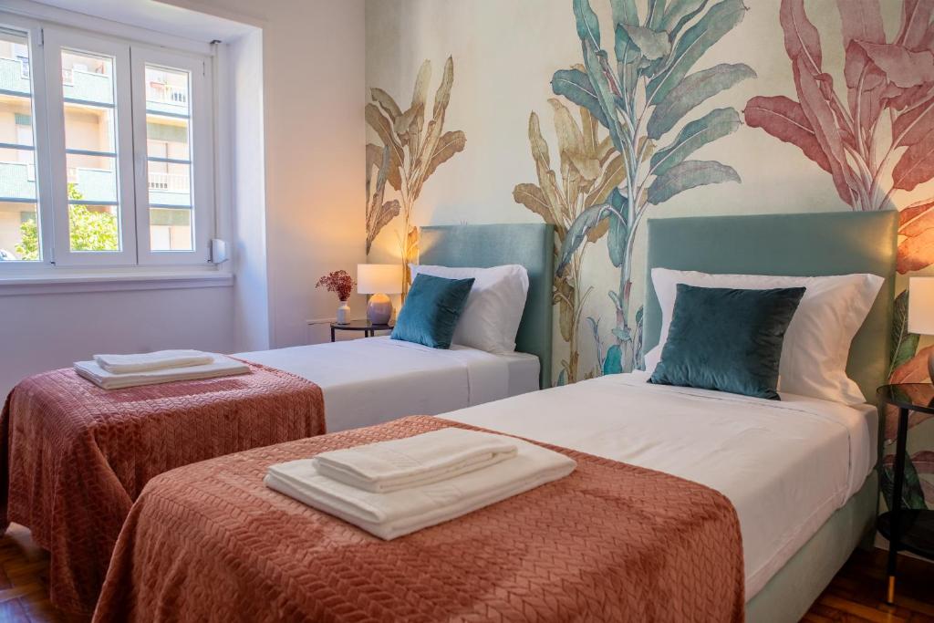 Säng eller sängar i ett rum på Succeed Campo Pequeno Suites