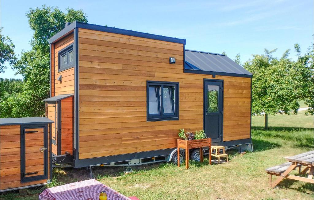a wooden tiny house in a yard with a table at Nice Home In Mayrhof With Wifi And 1 Bedrooms 