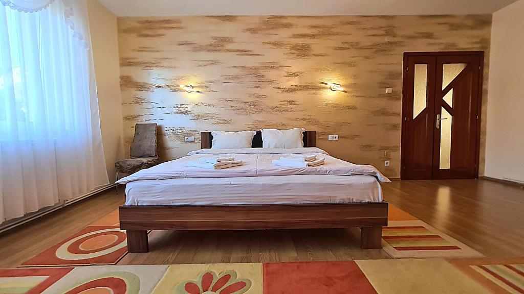 a bedroom with a large bed in a room at Perfect Residence Sibiu in Sibiu