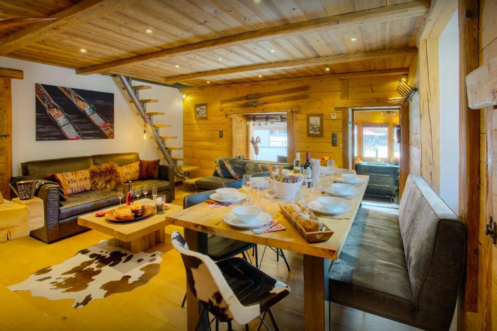 a living room with a table and a couch at Chalet Artedaz - OVO Network in La Clusaz