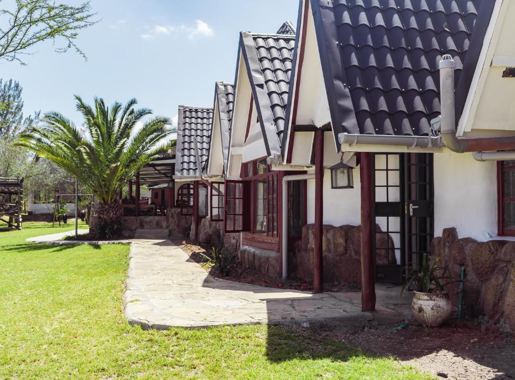 a house with a pathway leading to the front yard at Ndoto House-Maanzoni ,Athi River by Nest & Nomad in Machakos