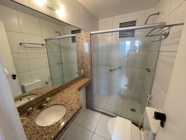 a bathroom with a sink and a glass shower at 952A golden fortaleza in Fortaleza