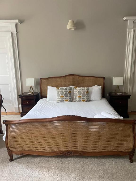 a bedroom with a large bed with two night stands at Private Guest Suite in Georgian Townhouse in City Centre in Edinburgh