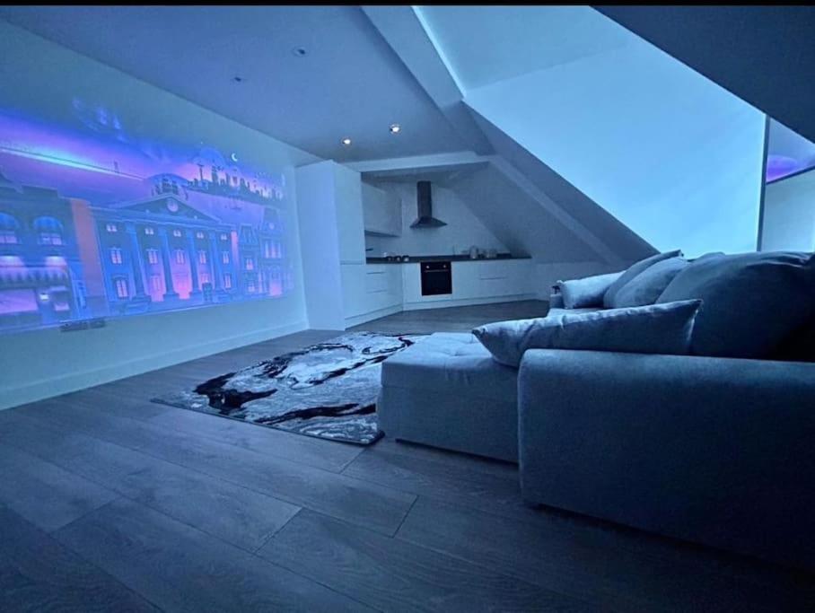 a living room with a couch and a large window at stunning cinematic 2 bed in Hendon