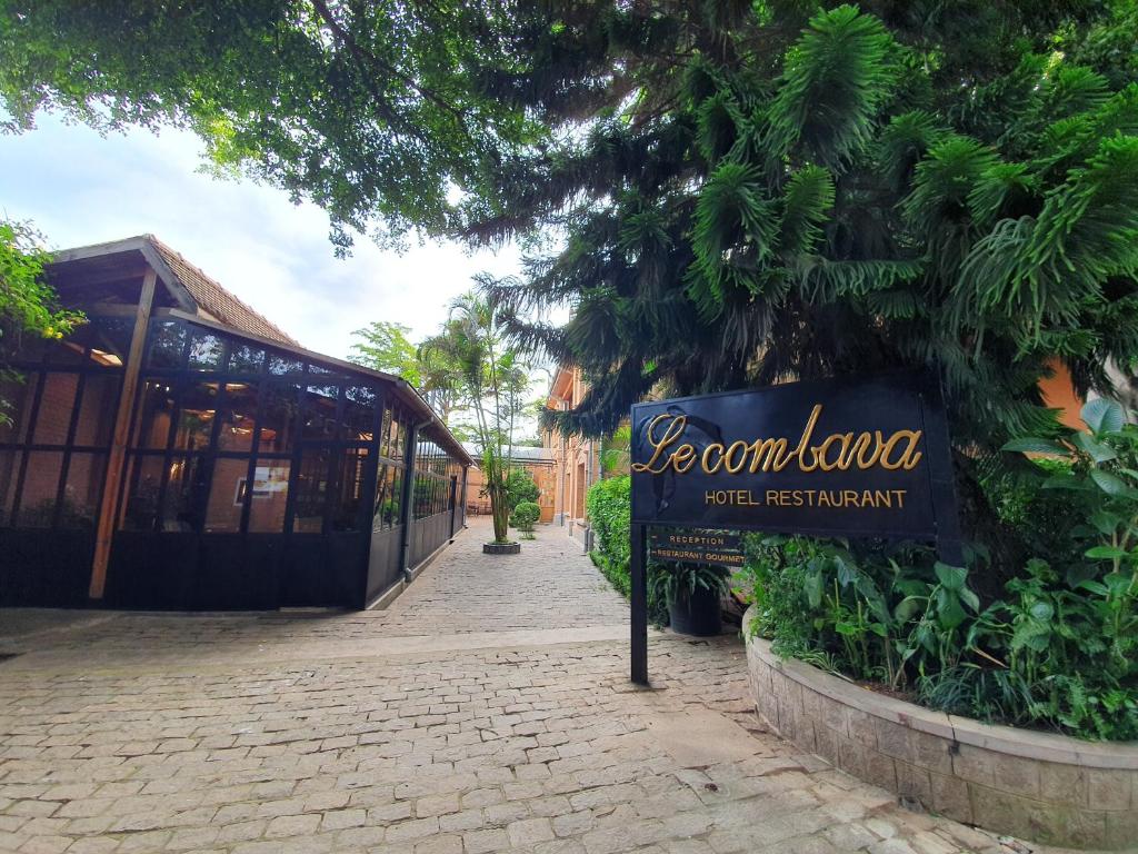 a sign for a restaurant in front of a building at Hôtel Restaurant LE COMBAVA in Antananarivo