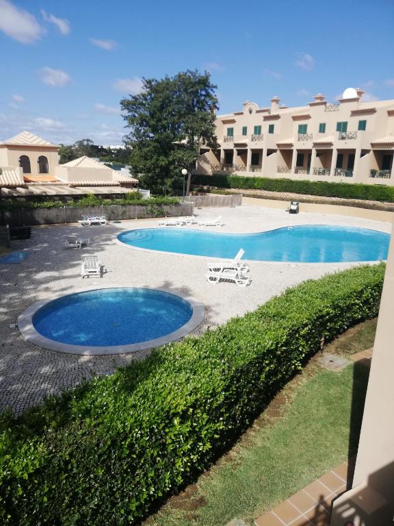 a view of a swimming pool in a resort at Villa V2 V in Olhos de Água