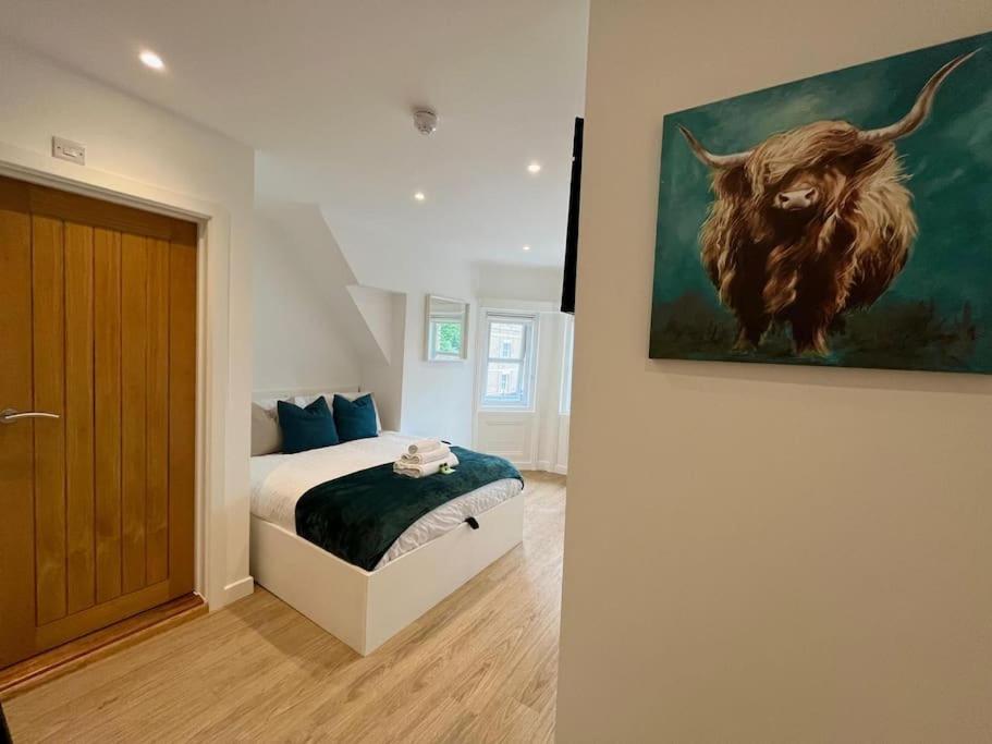 a bedroom with a painting of a bull on the wall at 310, The Kové, West Hill Road in Bournemouth