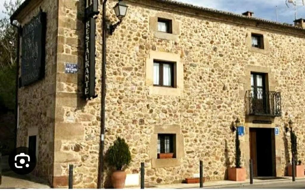 a large stone building with a window at Hotel la posada de Numancia in Garray
