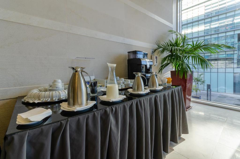 A drinks and coffee station set beside a window.