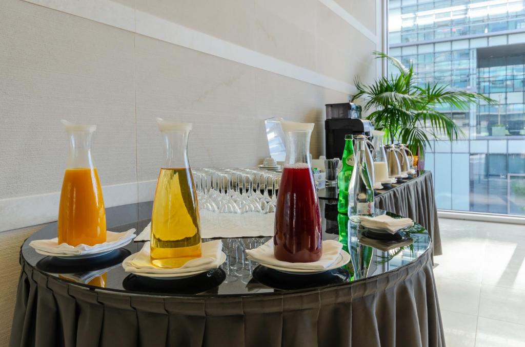 A colorful self-service drinks display with juices and bottled water.