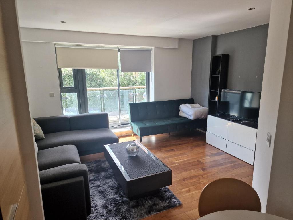 a living room with a couch and a tv at Immaculate 1-Bed Apartment in London in London