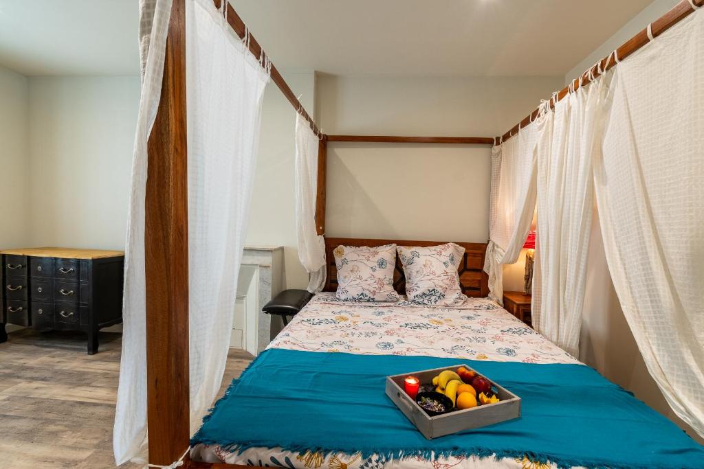 a bedroom with a bed with a tray of fruit on it at Standing Vieux port 110 m2, Marseille in Marseille