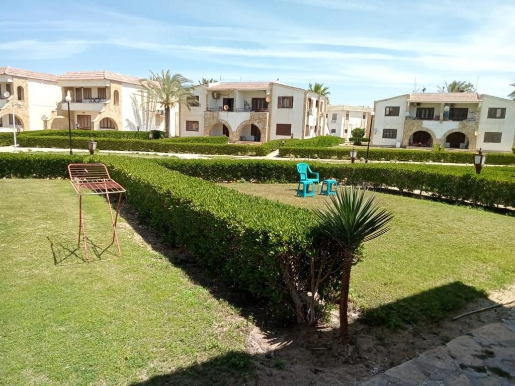 un parque infantil en un patio con edificios al fondo en شاليه بقرية سما العريش en Arish