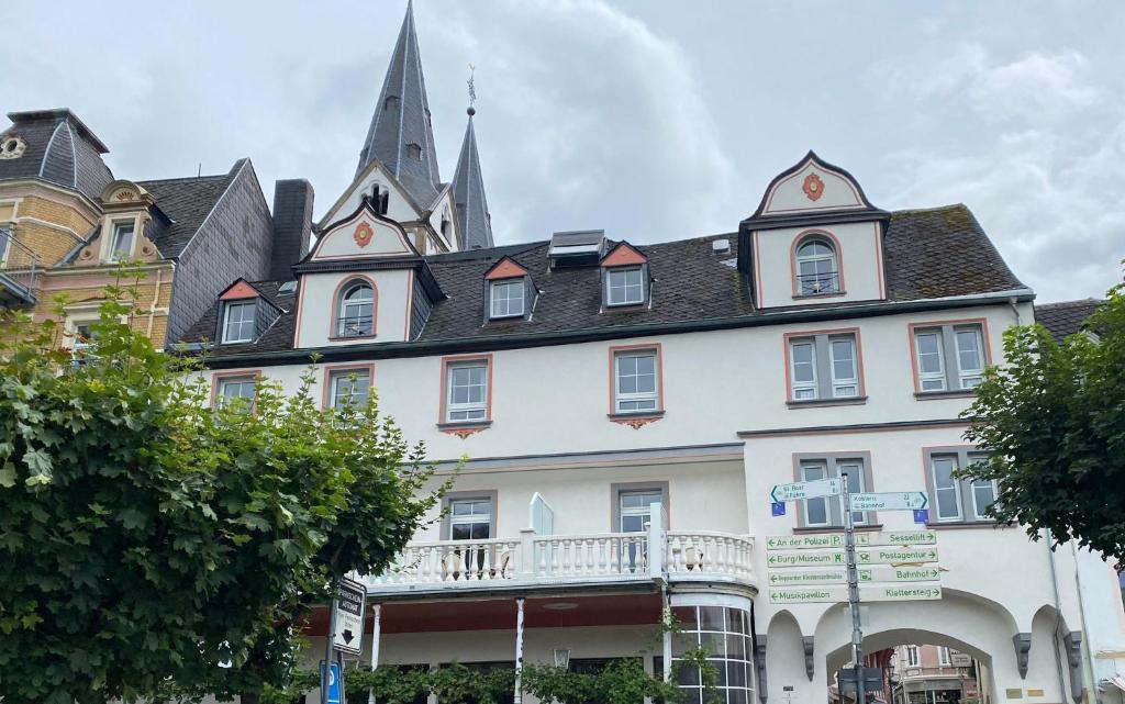 a large white building with a turret at Rheinhotel Zur Krone in Boppard