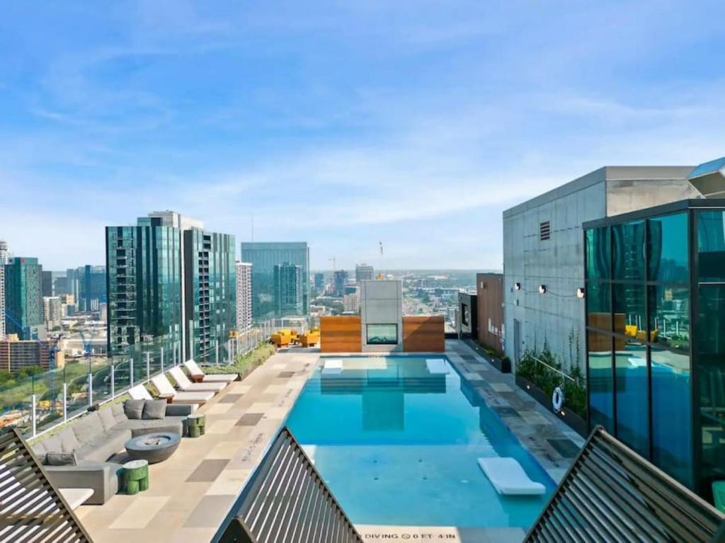 a swimming pool on the roof of a building at NEW 1BR Scenic Retreat with Rooftop pool on Rainey St in Austin
