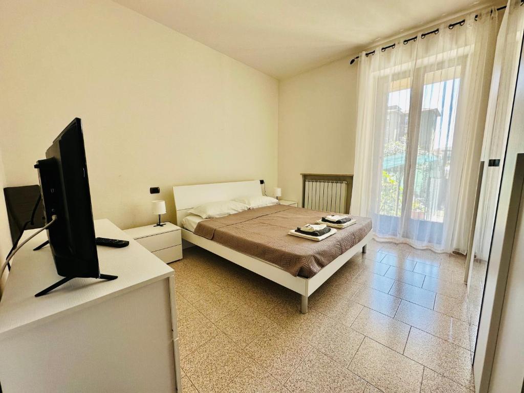 a bedroom with a bed and a flat screen tv at Civico 56 in Verona
