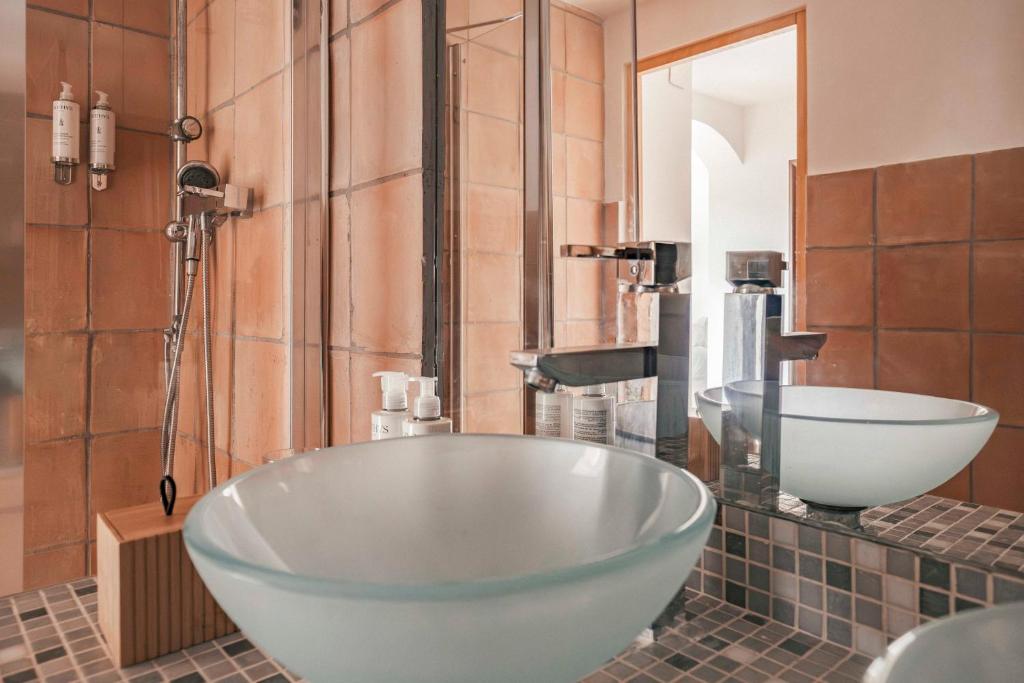 a bathroom with a large tub and a sink at Surplage Hotel Cavalière in Le Lavandou