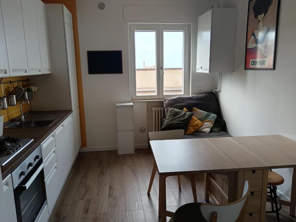 a kitchen and living room with a couch and a table at La casetta di Cecilia in Trani