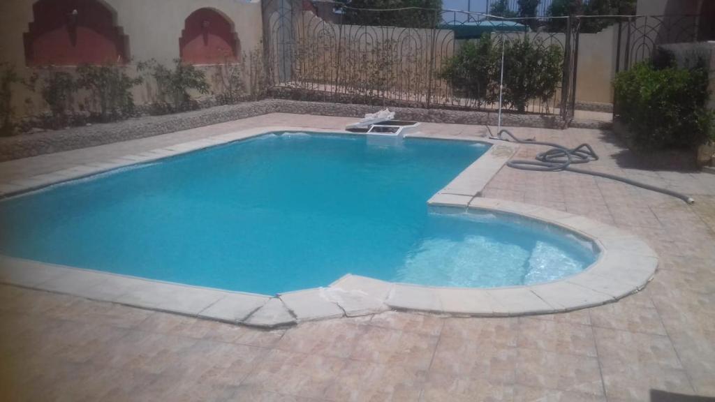 a small swimming pool in a yard with a brick patio at الغردقه البحر الاحمر مبارك 6 in Hurghada