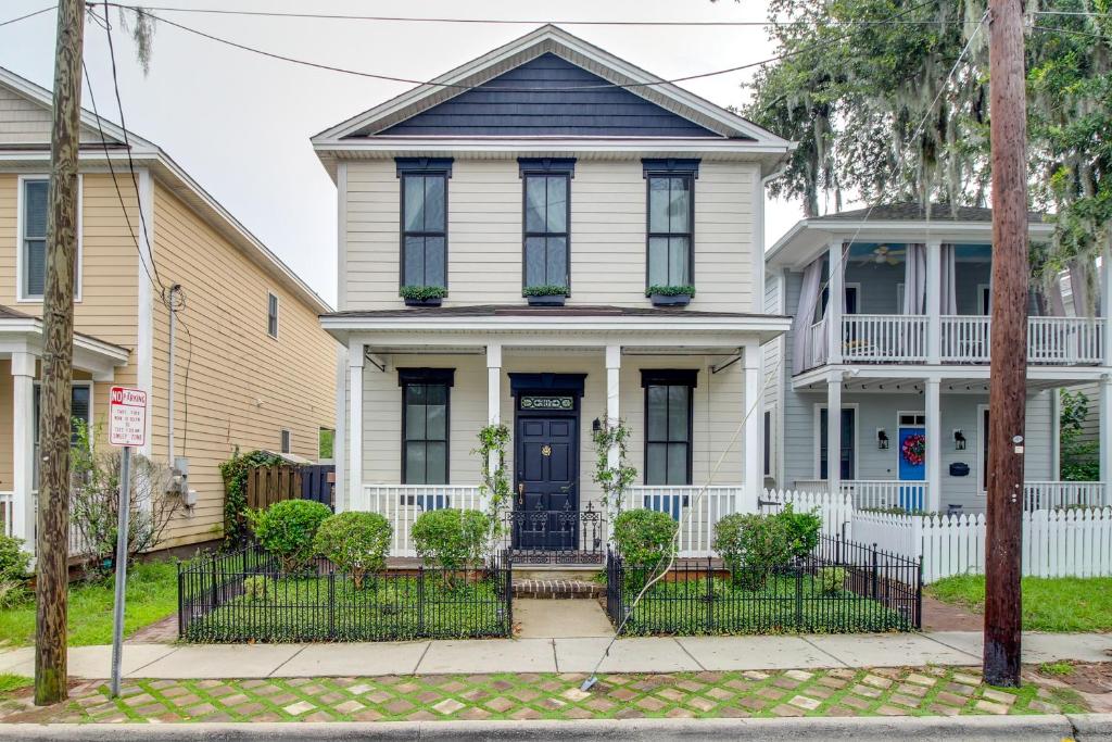 a white house with a blue door at Chic Thomas Square Home in Walkable Location! in Savannah