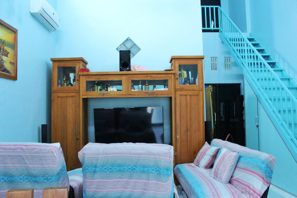 a living room with a fireplace and a tv at KJ Blue Gate Senggigi in Senggigi 