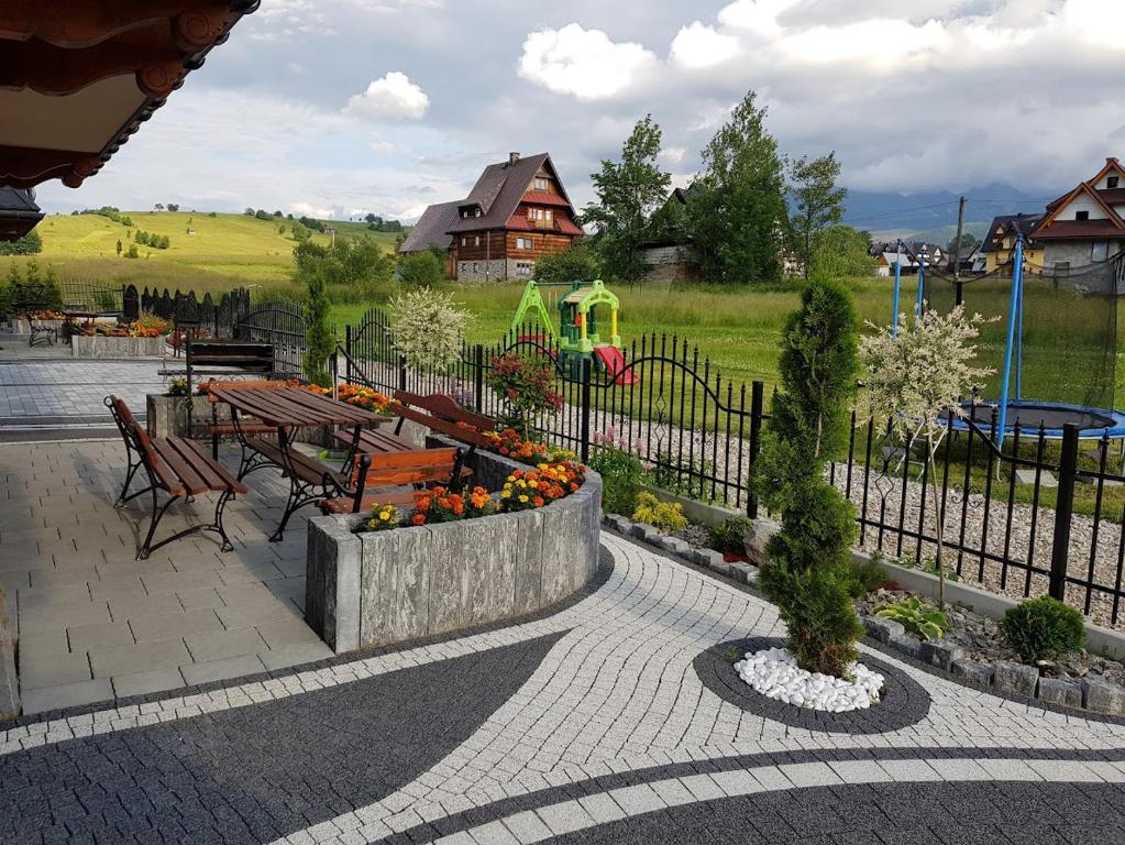 a park with a bench and a playground with at Resort & Willa Adrian Domek Delux in Zakopane