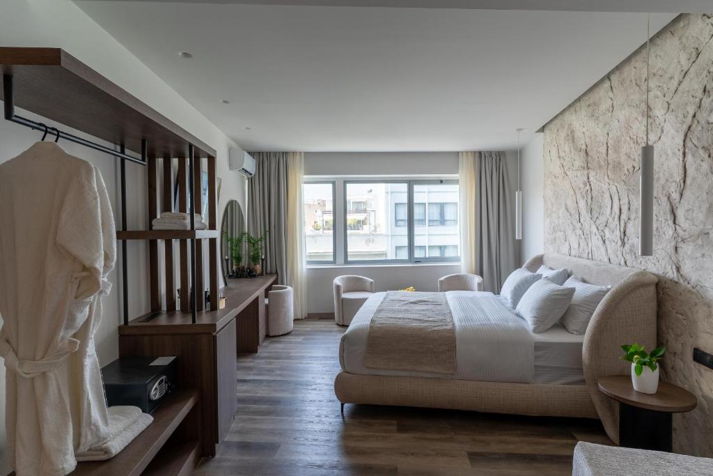 a bedroom with a bed and a large window at Athens Design Suites in Athens