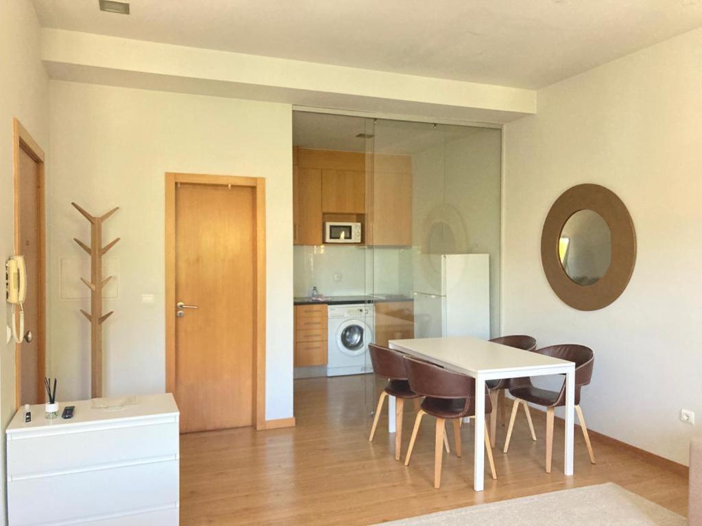 a kitchen and dining room with a table and chairs at Coreto Bento Freitas in Vila do Conde