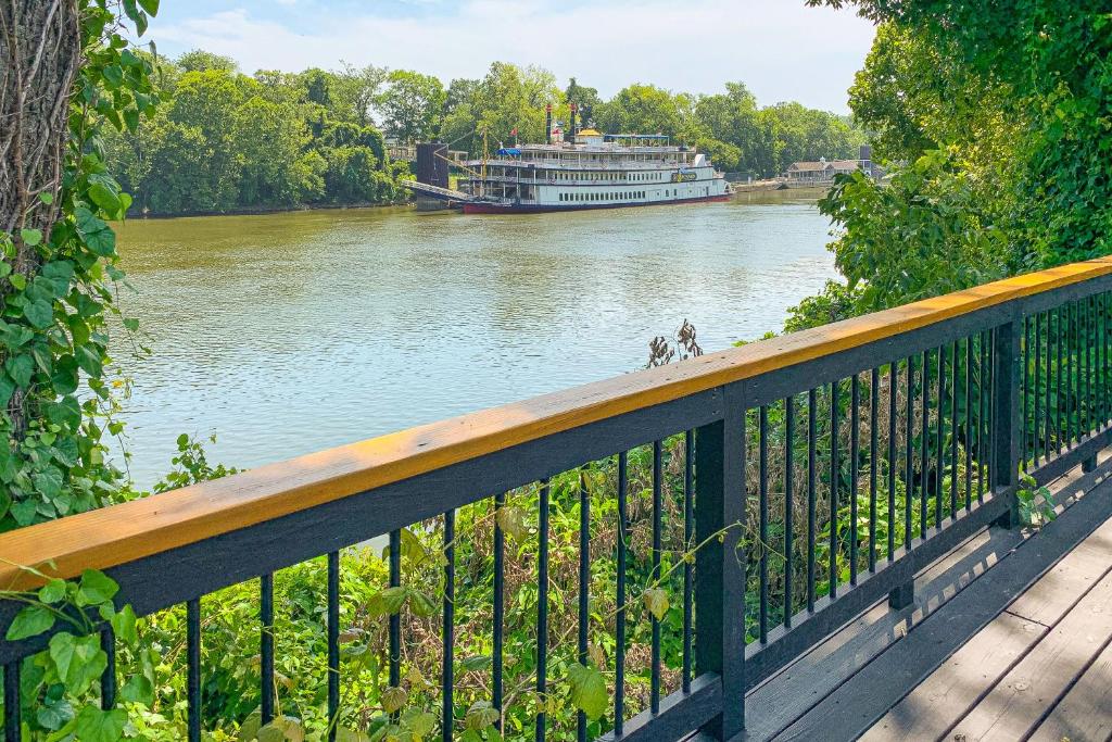 a boat on the river with a dog on a bridge at Inglewood Rose in Nashville