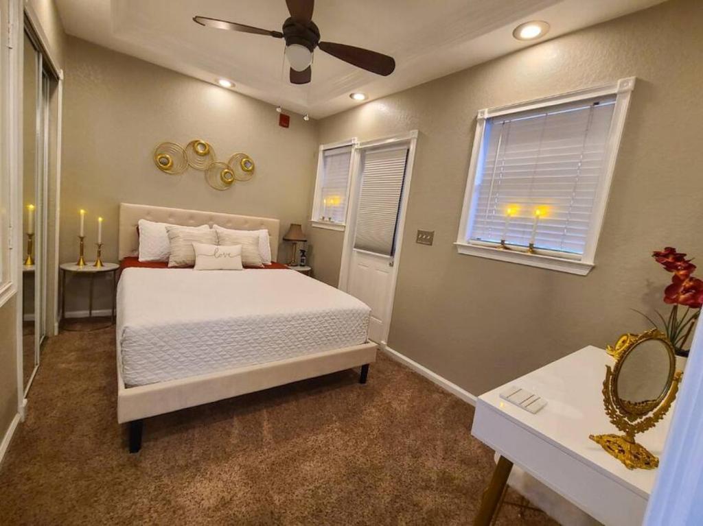 a bedroom with a bed and a ceiling fan at Romance in the City 1 Bdrm Studio in Downtown St Pete in St Petersburg