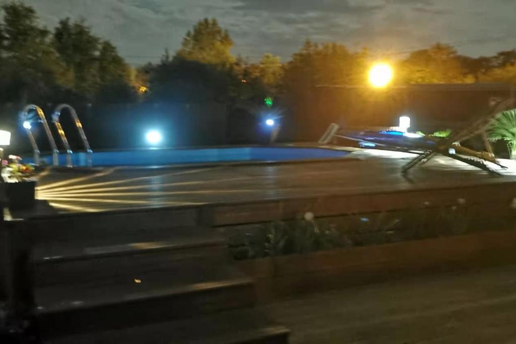 a swimming pool at night with lights on at MAISON &amp; PISCINE PRIVES,PLAGES OCEAN ET LAC A 10 kms in Linxe