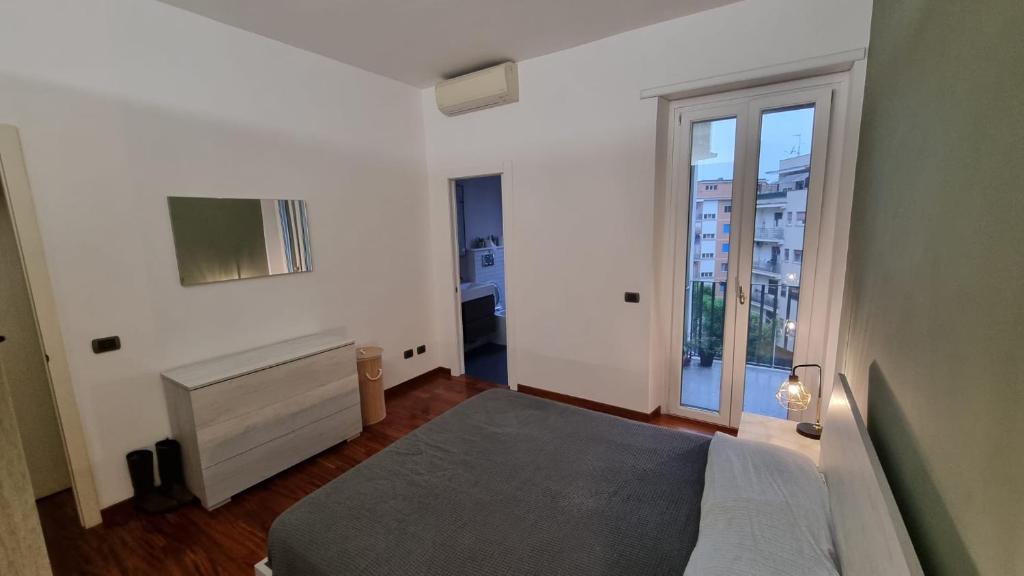 um quarto com uma cama e uma grande janela em Quarto Piano - intero alloggio a Roma em Roma