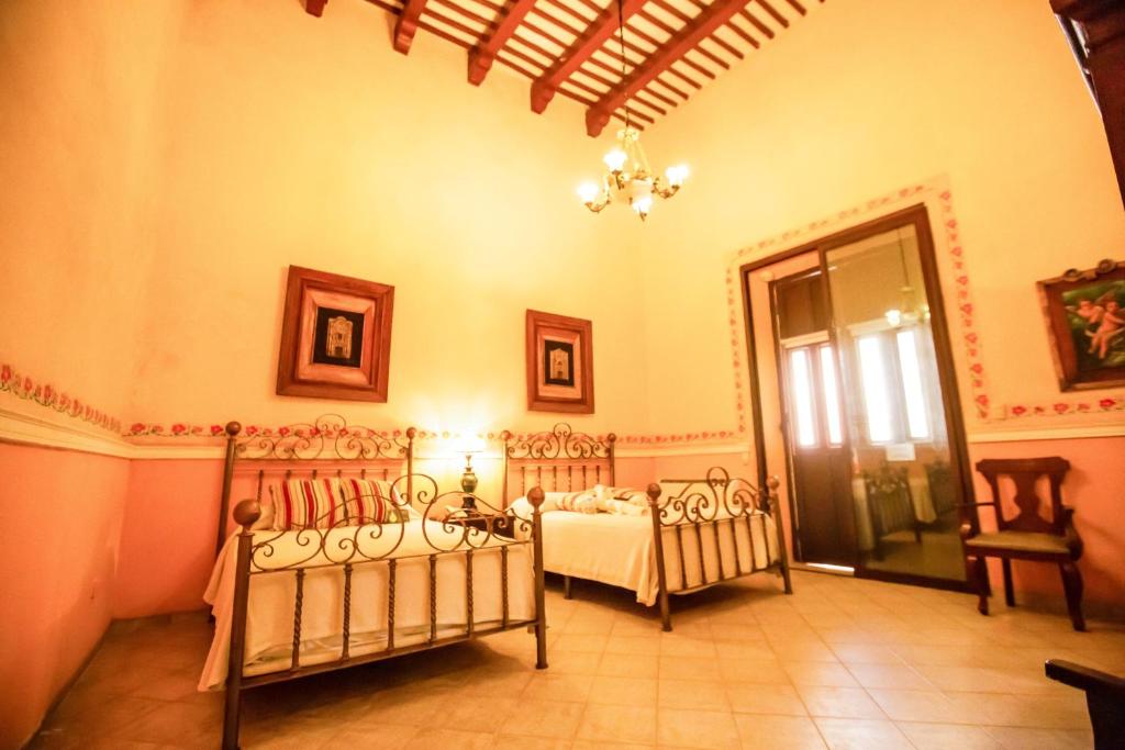 Postel nebo postele na pokoji v ubytování Hotel Boutique La Mision De Fray Diego